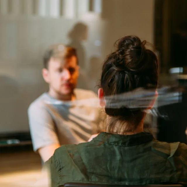 Two people sitting face to face in conversation