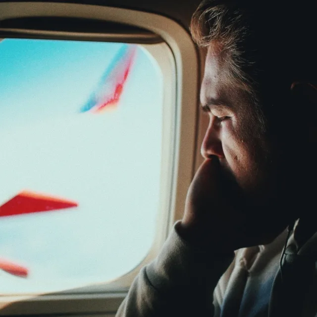 Anxious passenger looking at the plane's wing through the window