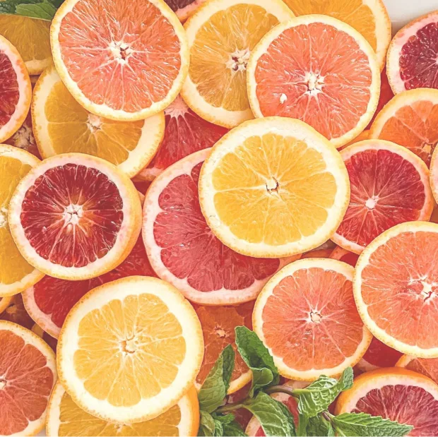 Slices of oranges and pink grapefruit, with a few mint leaves