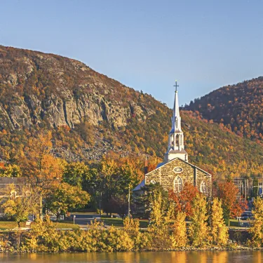 Mont Saint-Hilaire and its church by the Richelieu River, in autumn